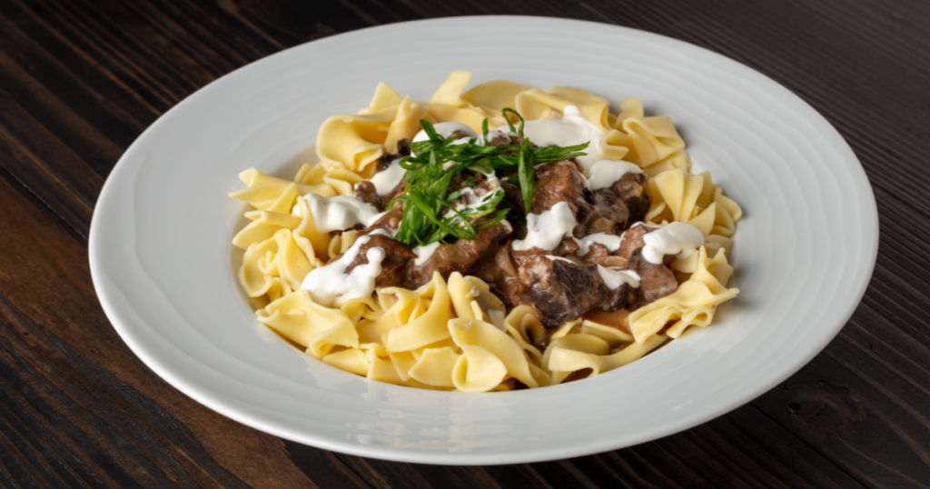 Beef stroganoff on a white plate. 