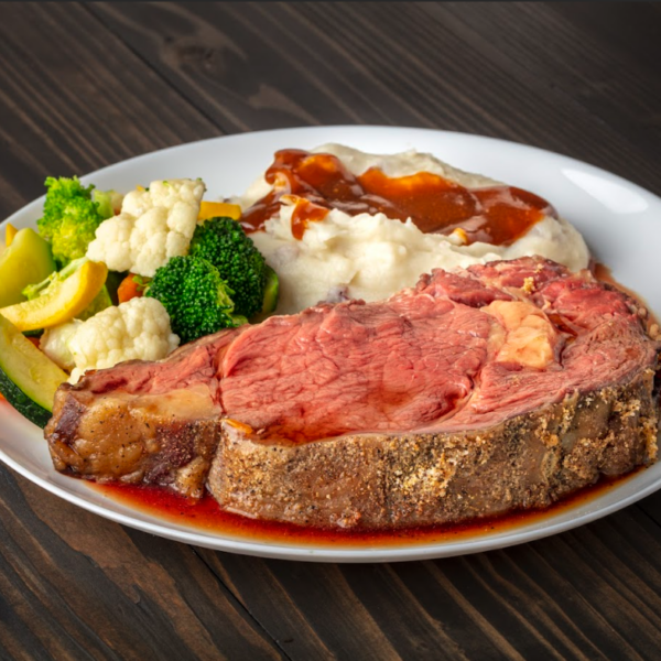 grass-fed prime rib paired with mashed potatoes and steamed vegetables.
