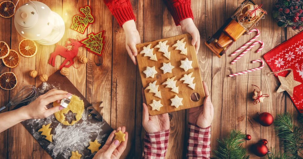 A family making holiday cookies — one of the best Christmas activities! Enjoy fun family Christmas activities in Sacramento, festive holiday meals at Brookfields Restaurant, and creative Christmas things to do with kids.